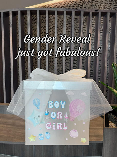 White gender reveal gift box with soft tulle and pastel designs featuring clouds, stars, and hot air balloons. "Boy or Girl" text on the front. Perfect for a fabulous gender reveal celebration.