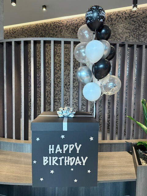 Black & Silver Birthday Box with Balloons Elegant black birthday gift box with silver ribbon, stars, and a "Happy Birthday" message. Paired with a stylish bunch of black, silver, white, and transparent helium balloons β perfect for a classy celebration.